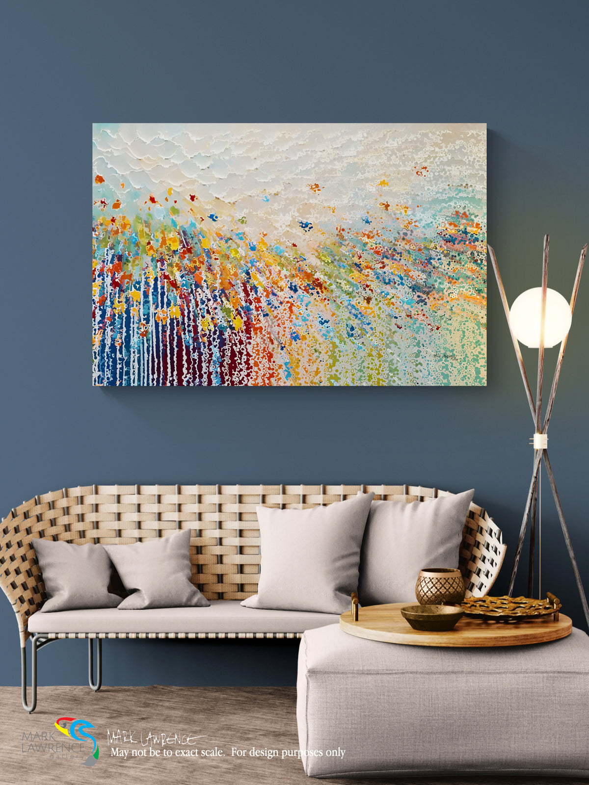 An abstract canvas painting with vibrant brushstrokes in blue, yellow, orange, red, and white, displayed on a dark blue wall above a modern woven sofa in a styled living room setting.